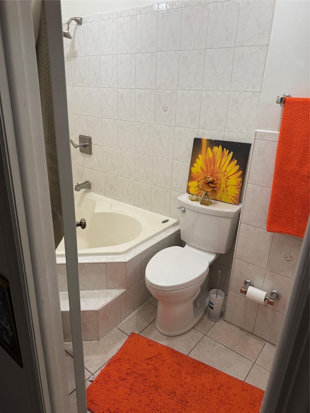 bathroom with toilet, tiled shower / bath, and tile patterned flooring