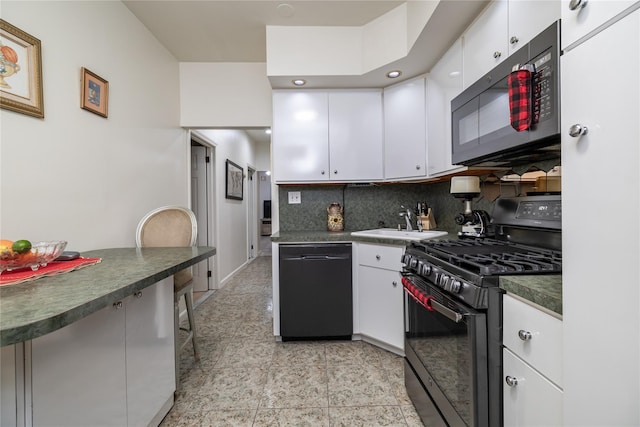 kitchen with a sink, white cabinetry, decorative backsplash, black appliances, and dark countertops