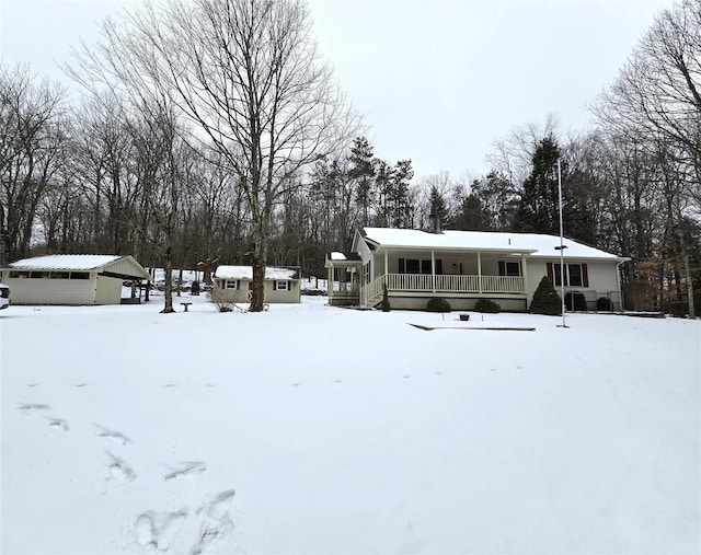 exterior space with an outbuilding, covered porch, and a garage