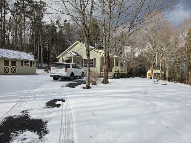 yard covered in snow featuring a storage shed