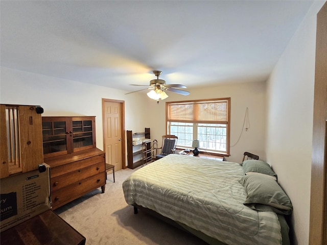 bedroom with ceiling fan and light colored carpet