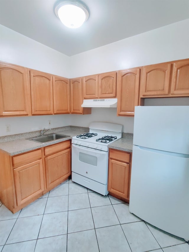 kitchen featuring light tile patterned floors, light brown cabinetry, sink, and white appliances