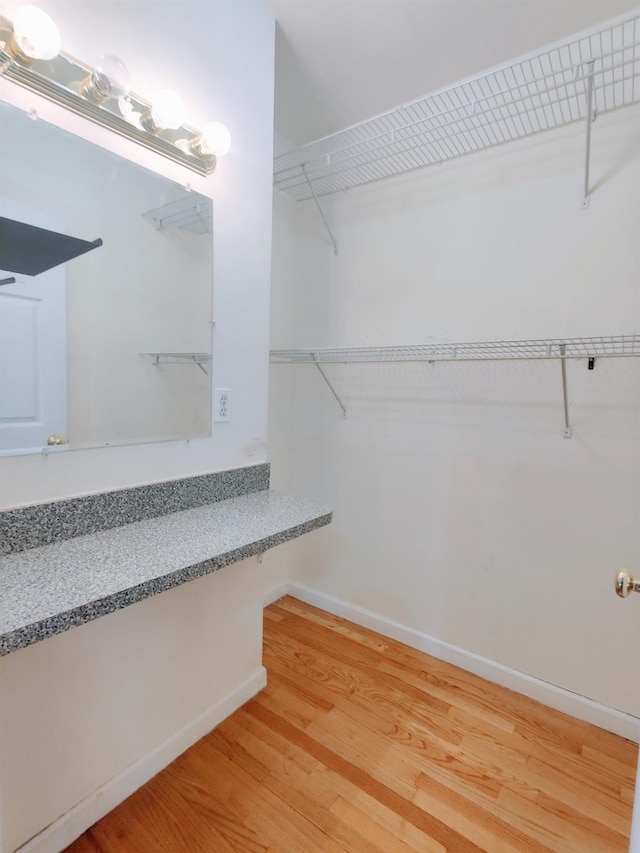 spacious closet featuring hardwood / wood-style flooring