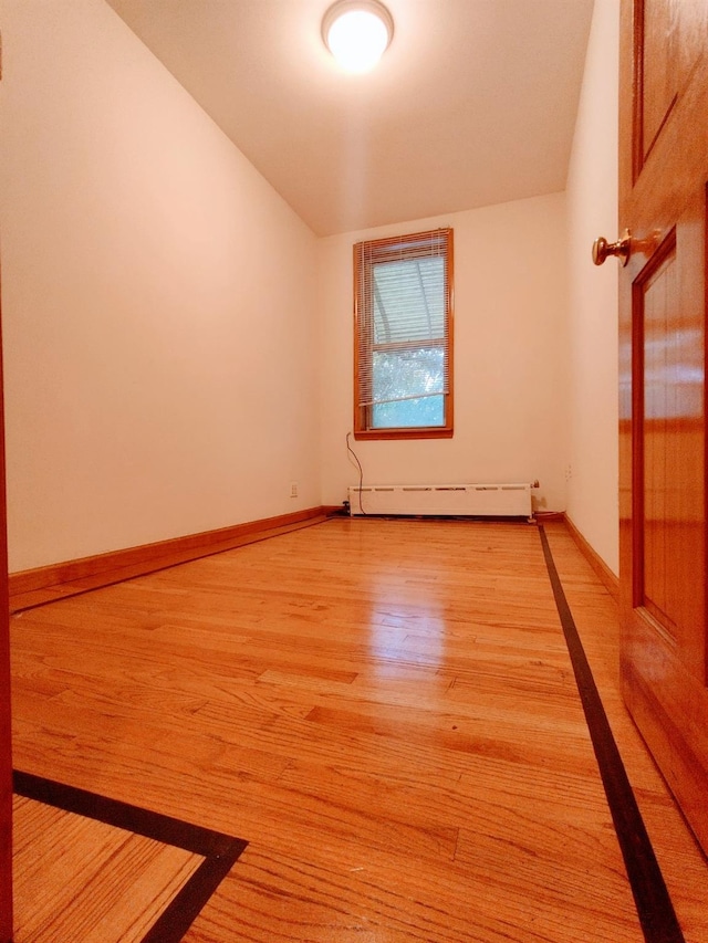 empty room featuring light hardwood / wood-style floors and a baseboard radiator