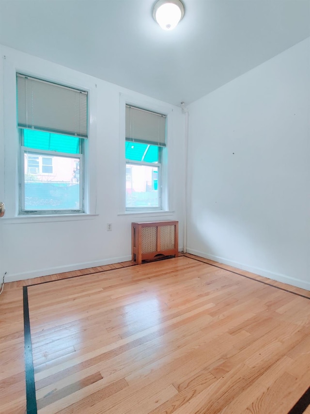 spare room with light hardwood / wood-style flooring