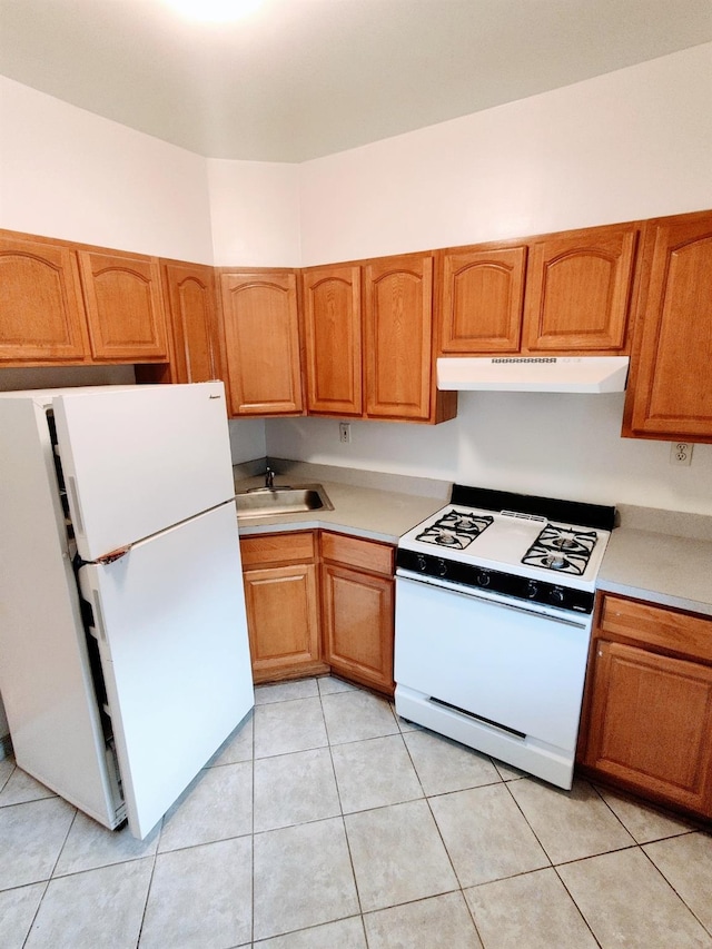 kitchen featuring sink, white appliances, and light tile patterned floors