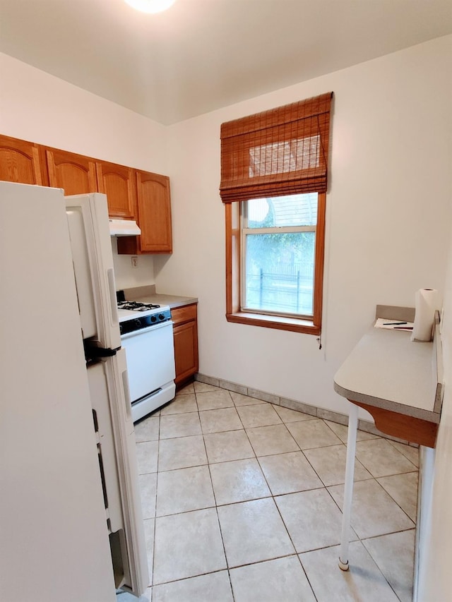 kitchen with white appliances and light tile patterned floors