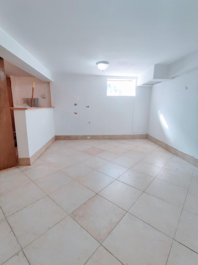 basement with light tile patterned flooring