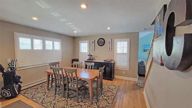 dining room with light hardwood / wood-style flooring and a baseboard radiator