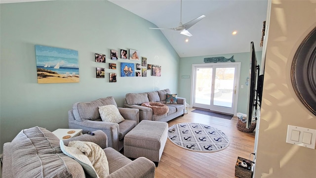 living room with light wood-type flooring, vaulted ceiling, and ceiling fan