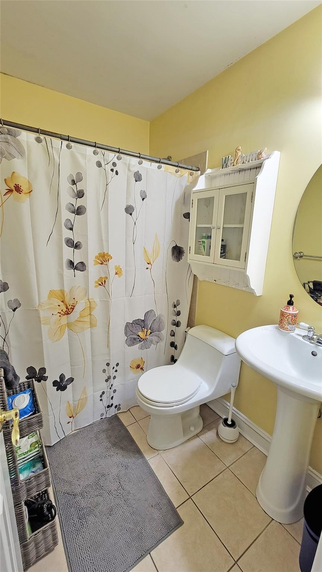 bathroom featuring toilet and tile patterned flooring