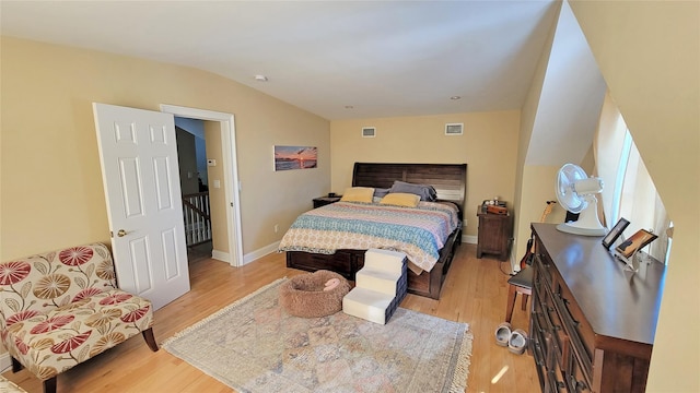 bedroom featuring light wood-type flooring and vaulted ceiling