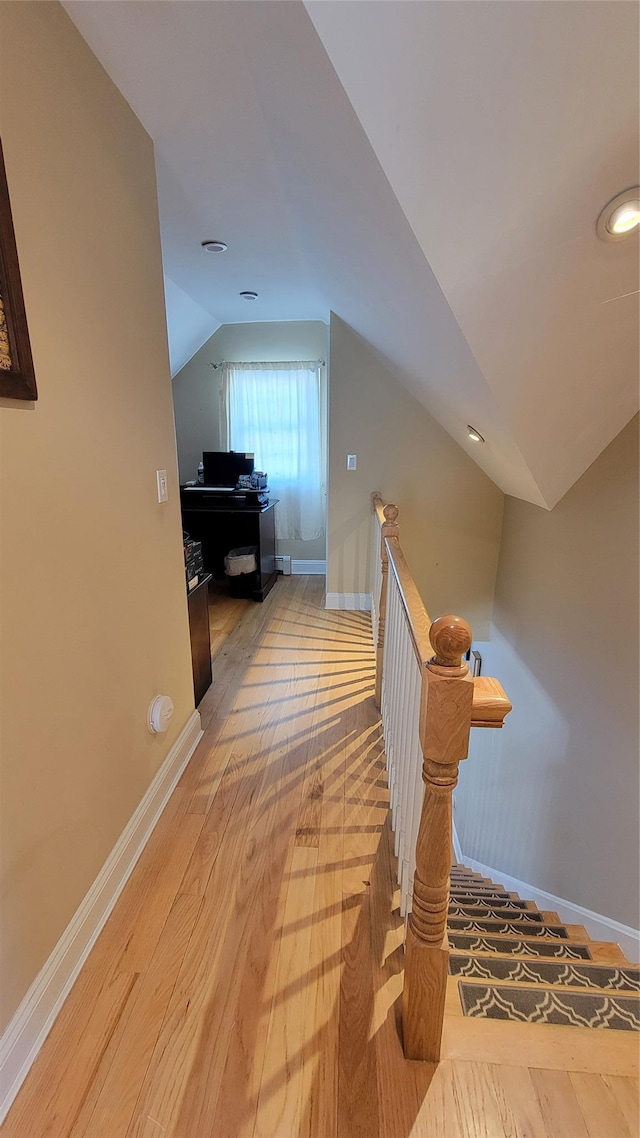 interior space with vaulted ceiling and hardwood / wood-style floors