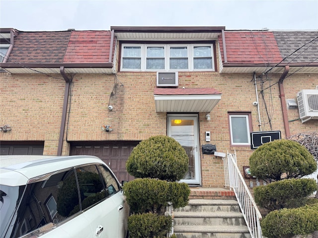 view of front of house featuring ac unit and a garage