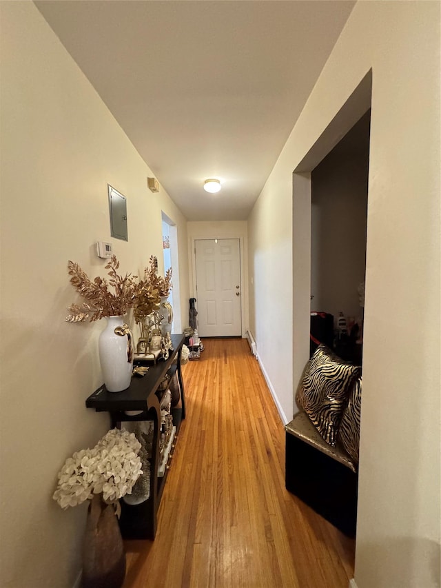 corridor with light hardwood / wood-style floors