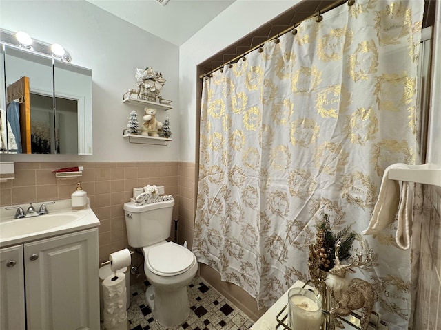 bathroom with toilet, vanity, tile walls, and a shower with curtain