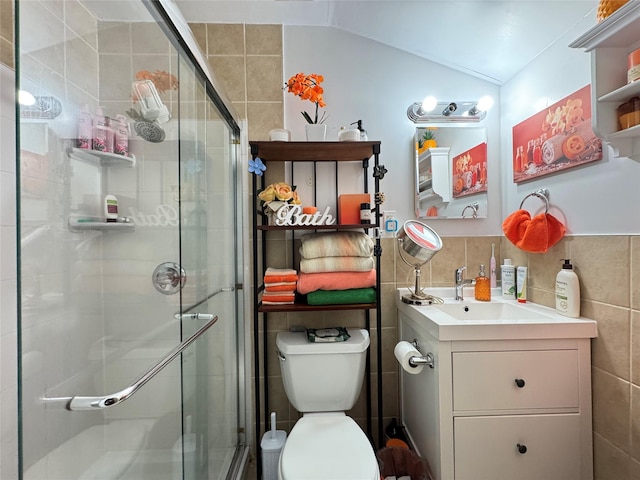 bathroom featuring tile walls, an enclosed shower, vanity, and toilet