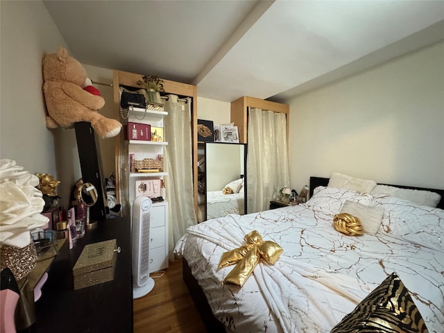 bedroom with wood-type flooring and a closet