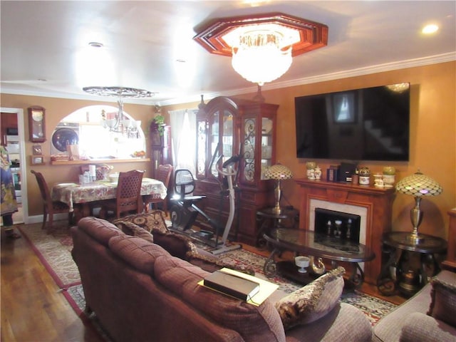 living room with hardwood / wood-style flooring and ornamental molding