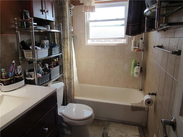 full bathroom with tile patterned flooring, vanity, tile walls, toilet, and shower / tub combo with curtain