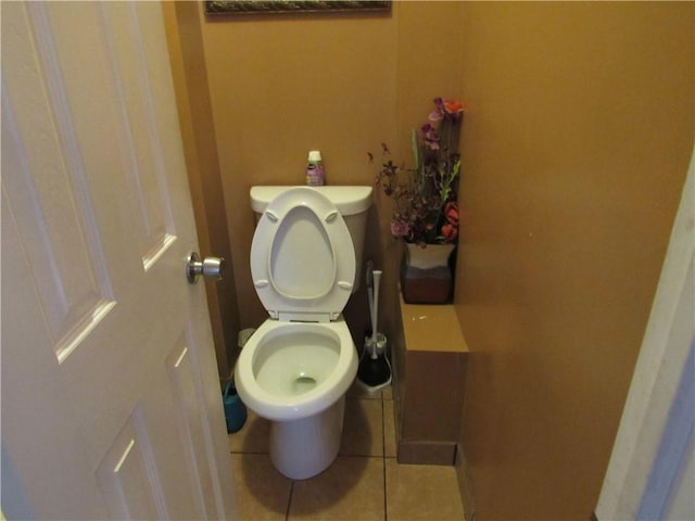 bathroom featuring toilet and tile patterned flooring