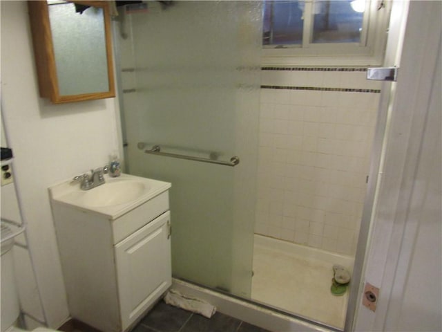 bathroom with tile patterned floors, vanity, and a shower with shower door