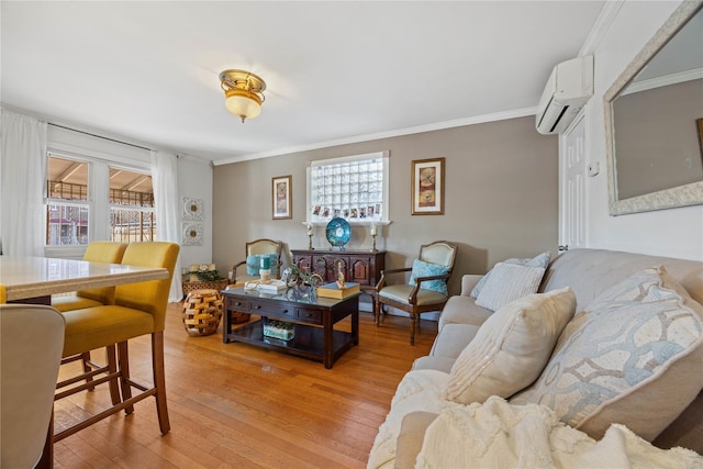 living room featuring light hardwood / wood-style flooring, crown molding, a wall mounted AC, and a healthy amount of sunlight