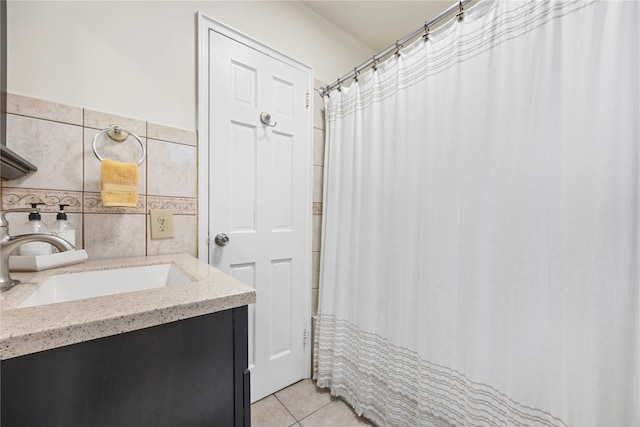 bathroom featuring tile patterned flooring, tile walls, and vanity