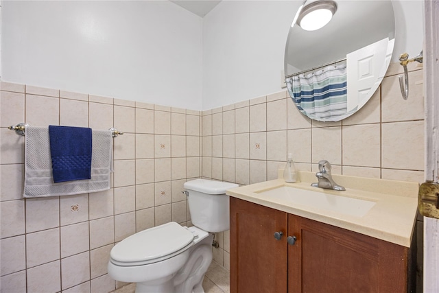 bathroom with tile walls, toilet, and vanity