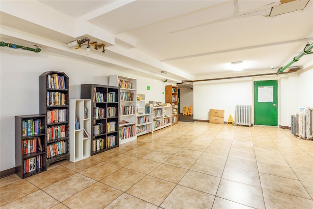 misc room featuring radiator heating unit and light tile patterned flooring