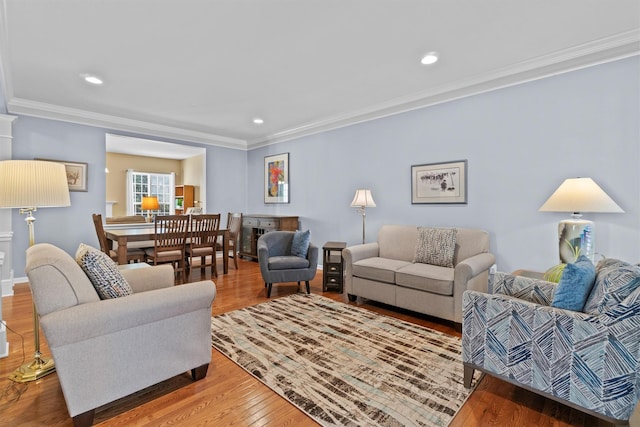 living room featuring crown molding and hardwood / wood-style floors