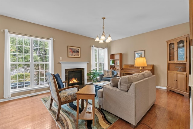 living room with plenty of natural light and light hardwood / wood-style flooring