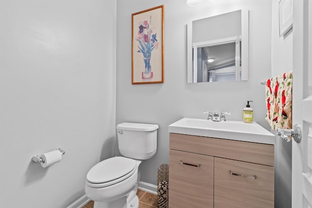 bathroom featuring toilet, vanity, and tile patterned flooring