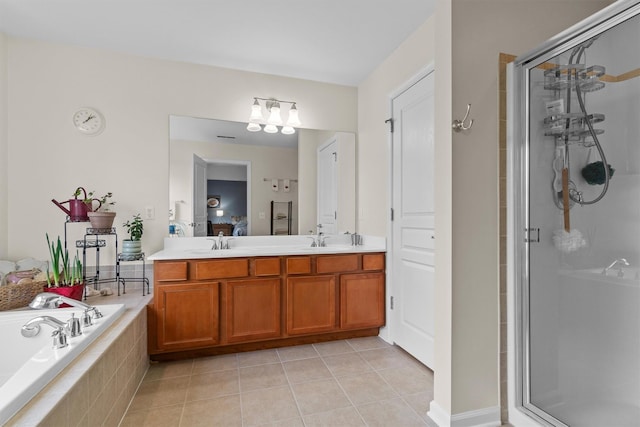 bathroom with shower with separate bathtub, vanity, and tile patterned flooring