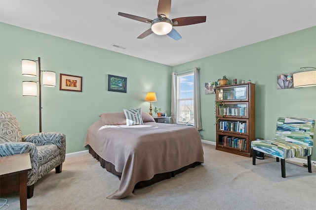 bedroom featuring light carpet and ceiling fan