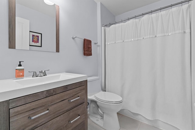 bathroom featuring toilet, vanity, a shower with curtain, and tile patterned flooring