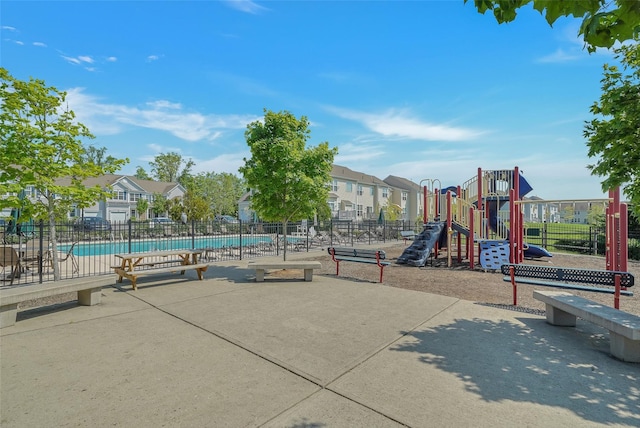 view of playground with a community pool