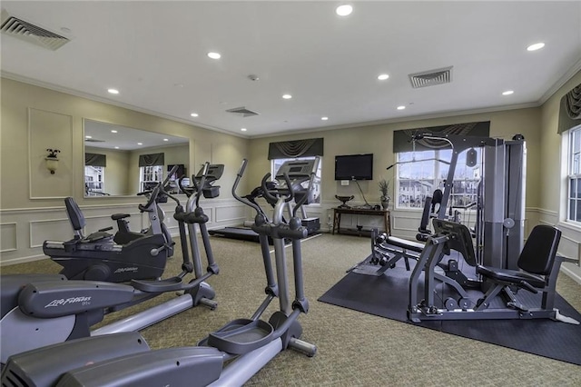 gym with crown molding and carpet floors