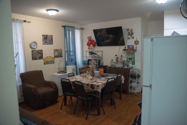 dining room with hardwood / wood-style flooring and plenty of natural light