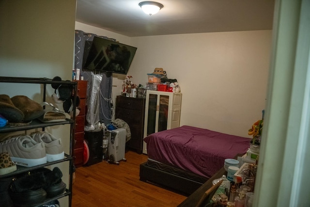 bedroom with hardwood / wood-style flooring