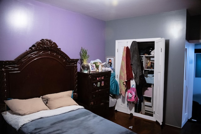 bedroom with dark hardwood / wood-style flooring