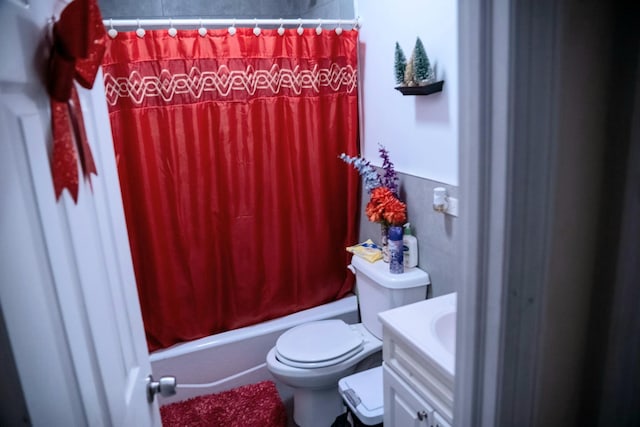 full bathroom with toilet, vanity, and shower / tub combo with curtain