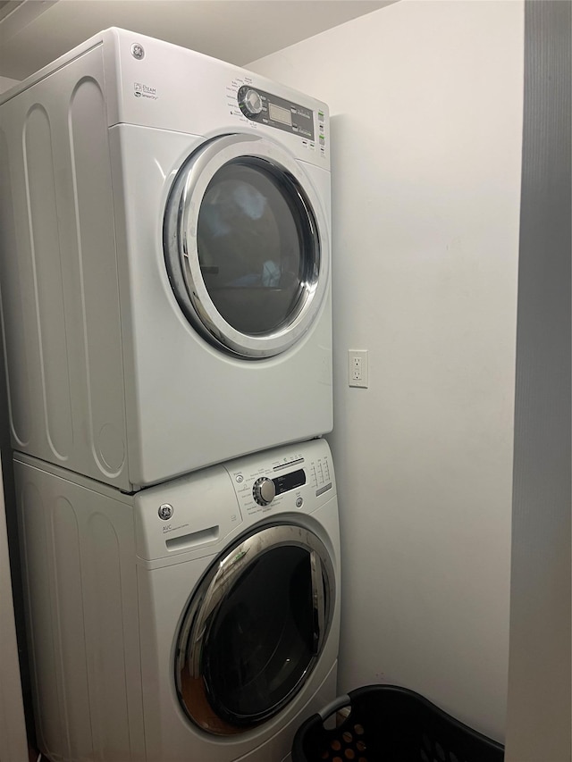 washroom featuring stacked washer and dryer