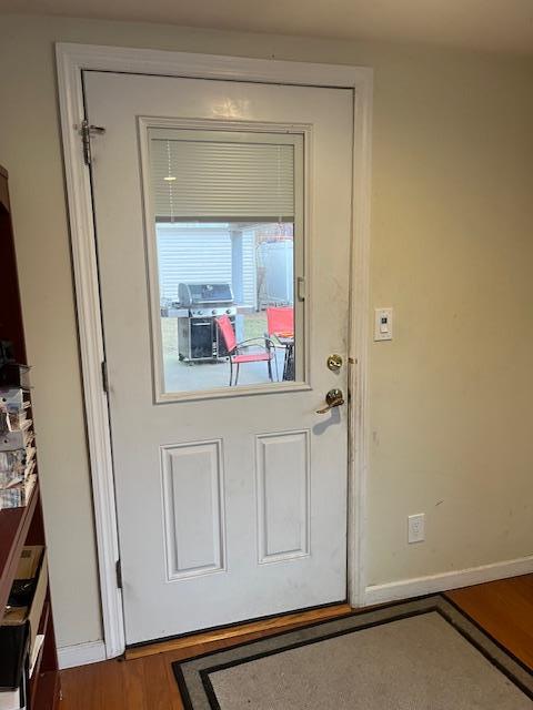 doorway with dark hardwood / wood-style flooring