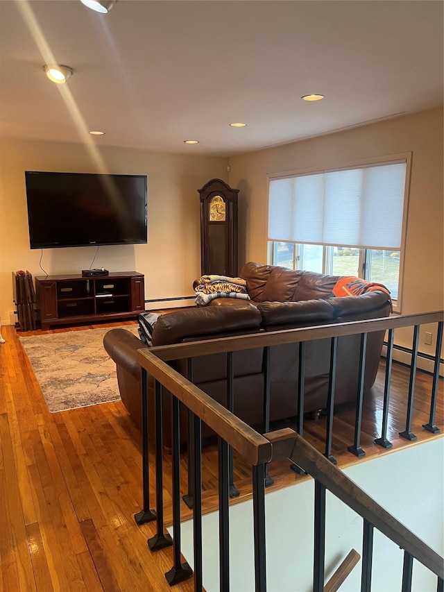 living room with hardwood / wood-style flooring and a baseboard heating unit