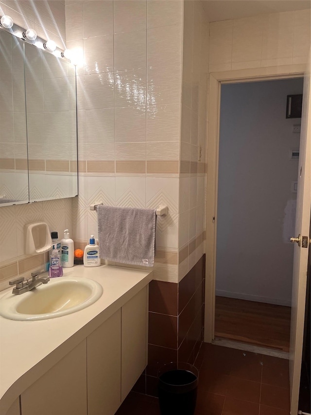 bathroom featuring tile walls, tile patterned floors, and vanity