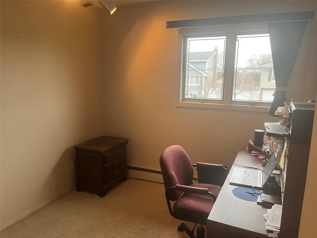 carpeted office space featuring a baseboard heating unit