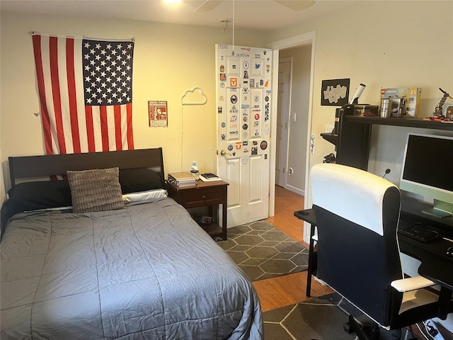 bedroom with dark wood-type flooring and ceiling fan