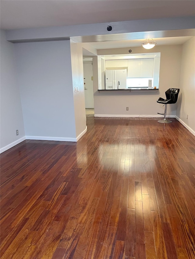 unfurnished living room with dark hardwood / wood-style floors