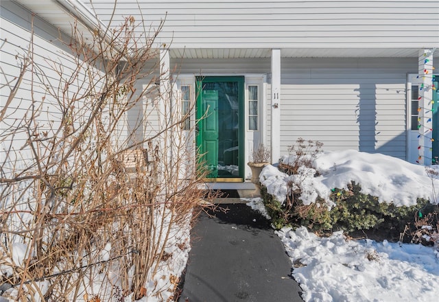 view of snow covered property entrance